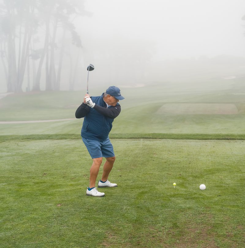 Top of the backswing on a foggy tee box
