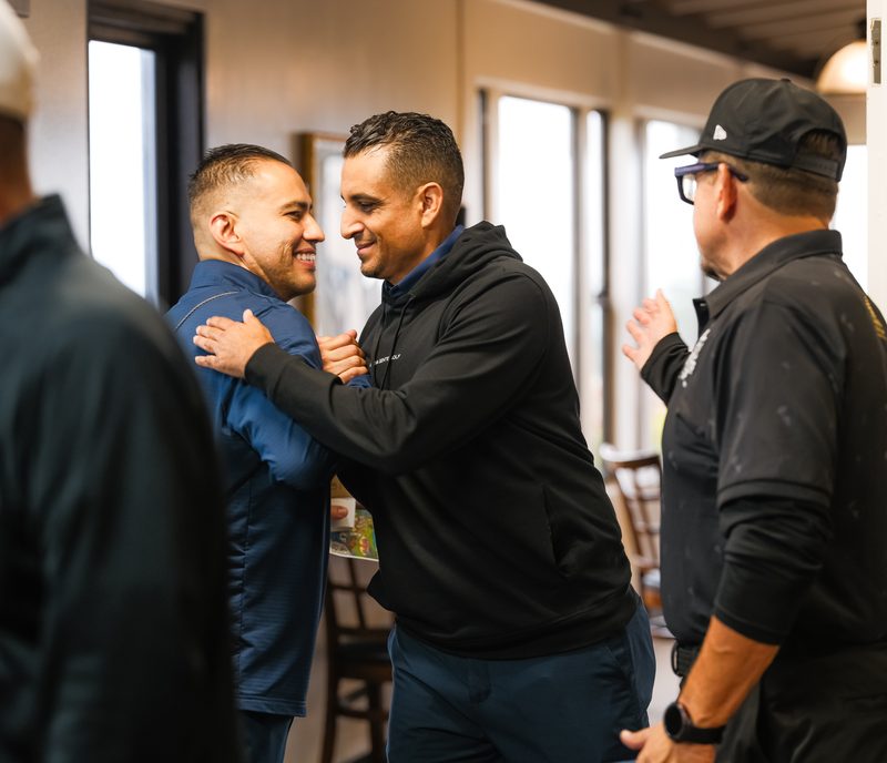 A warm embrace in the doorway as brothers arrive