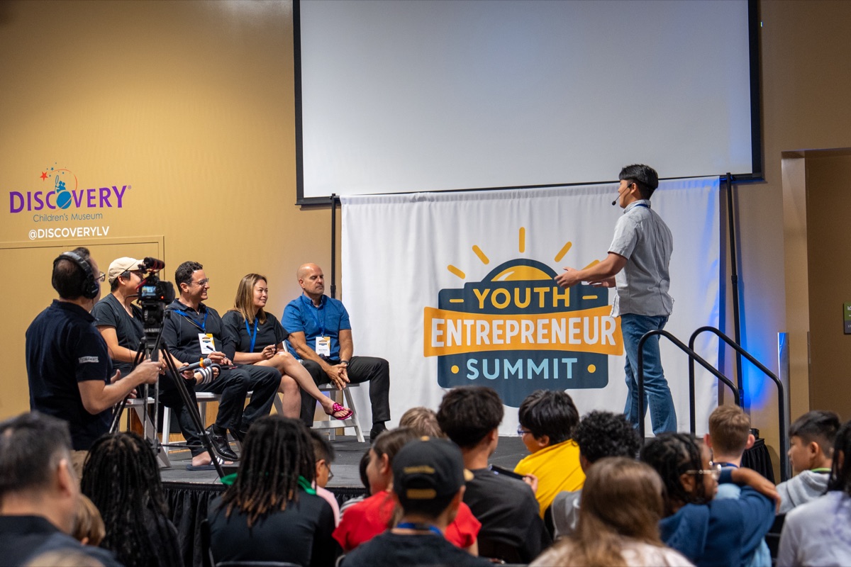 A speaker shares ideas with attendees at a previous YES summit